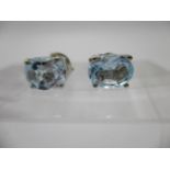 A pair of blue topaz stud earrings in silver settings