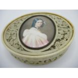 A 19th century ivory box of oval form, the pierced and carved lid inset with the head and shoulder