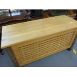 A modern pine blanket chest with lattice design to the sides