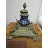 A Victorian brass desk inkwell with porcelain well and pineapple finial, stamped marks to base
