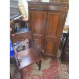 A reproduction cabinet having four panelled cupboard doors flanked by two columns and standing on