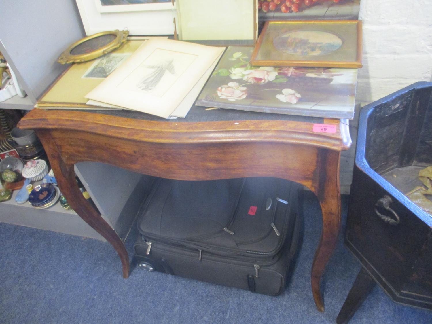 A 19th century French walnut serpentine table having a leather top, inset drawer and cabriole legs