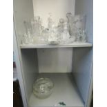 A mixed lot of cut table glass to include a ships decanter, other decanters, bowls and other items