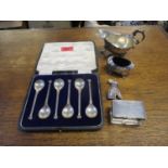 A set of six cased silver coffee spoons with Corinthian column handles and capital finials, on