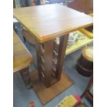 A modern square topped, burr table having a wine rack support, 46" h x 25 1/4"w