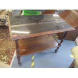 An early 20th century mahogany two tier trolley having a smoked glass top, 31" h x 38 1/2"w,