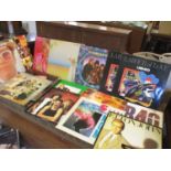 A collection of 47 vinyl LP's and 12" records to include rock artists, UB40, Rod Stewart, Slade,