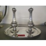 A silver salad set to include two bottles for vinaigrette and olive oil and an oval tray
