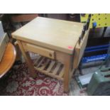 A Servus kitchen island butchers block with six knives and wine rack below