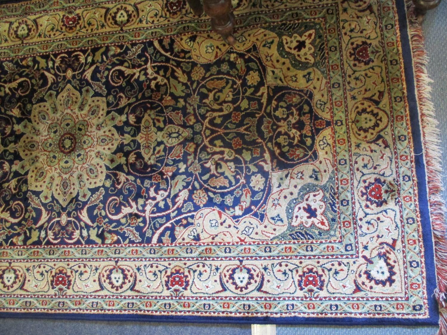 A Middle Eastern machine made woollen carpet having a navy ground with three large central motifs - Image 3 of 4