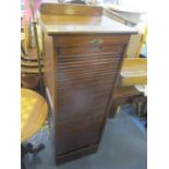An early 20th century oak tambour fronted cabinet, having nine pull out drawers 52 3/4 H x 19 1/4 W