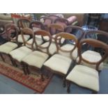 A matched set of twelve walnut framed, balloon back dining chairs with upholstered seats, on turned,