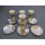 A silver and porcelain part coffee set comprising six silver saucers marked sterling, five pierced