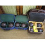 Two sets of four lawn bowls to include Drakes Pride, in travelling cases