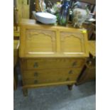 A modern antique style oak finished bureau, 38 1/2" x 29 5/8" x 16 1/2" and a matching stereo