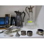 A quantity of silver plate to include a claret jug and napkin rings and mixed metalware, together