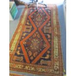 Two rugs to include a Turkish blue and orange ground rug having geometric designs and multiguard