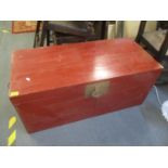 An oriental red lacquered blanket box having twin carrying handles, 17 1/4"h x 39 1/4"w