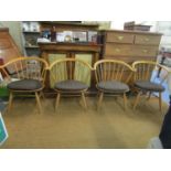 A set of four Ercol cow horn chairs with detachable brown upholstered seats, model 2056, stamp marks