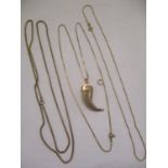 Two 9ct gold chains, a 9ct gold part covered claw and a gold coloured chain