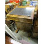 A Victorian walnut Davenport with hinged lid having inset leather scriber, four side drawers and