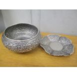 An Indian white metal embossed bowl and a small dish