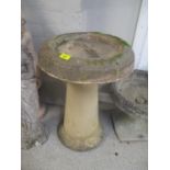 A composition garden circular bird bath on a raised base, 25" h x 17"w