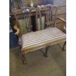 An American reproduction of a Chippendale double chair walnut salon sofa with striped upholstery