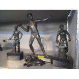 Four patinated bronze ornaments to include one of a man throwing a brick