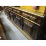A modern mahogany finished large sideboard having four drawers above four cupboard doors 31 1/2"h
