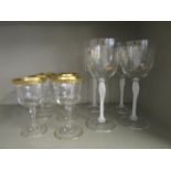 A set of six drinking glasses with rims, vertical moulded bowls on inverted baluster stem and