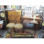A mixed lot to include a late 19th century two tier table, two fire fenders, a standard lamp, two