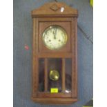 An early 20th century oak 8 day wall hanging clock
