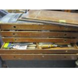 A vintage five drawer tool chest containing wooden handled and other tools