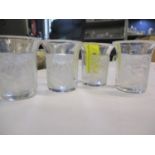 A set of four Lalique shot glasses each decorated with children