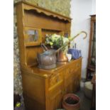 A modern antique style oak finished dresser with a plate rack, 69 1/2" x 55" x 20"