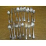 A selection of silver and white metal cutlery with family crests to the handles