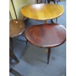 A nest of Ercol pebble tables in three different wood stains