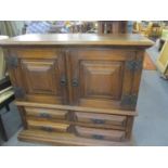 A reproduction American oak two door cabinet above four short drawers 39 x 45 x 20 together with a