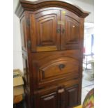 A modern mahogany finished large cabinet having four panelled doors and a fall flap 78 1/2"h x 44