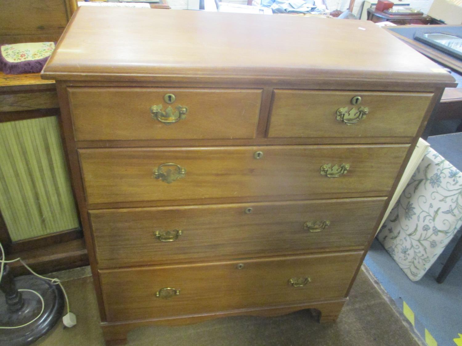 A late 19th/early 20th century walnut chest of two short and three long drawers on bracket shaped