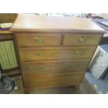 A late 19th/early 20th century walnut chest of two short and three long drawers on bracket shaped