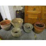 A pottery chimney pot and a selection of ceramic and garden concrete planters