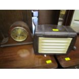 A Raymond Electric Ltd Magnavox Bakelite cased radio and an oak cased Napoleon hat mantle clock