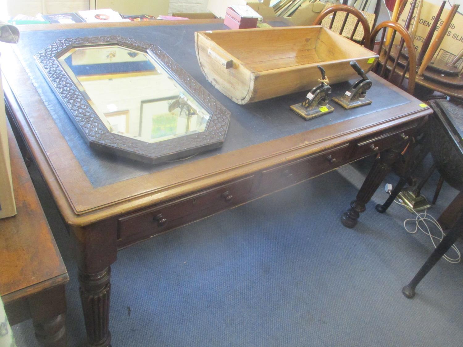 A Victorian mahogany library writing table having a leather top, inset drawers and fluted legs 29