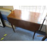 An early 20th century mahogany drop leaf side table with side drawer