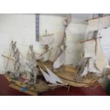 Two wooden model display boats on stands
