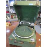 A retro record player and a green cased table top gramophone