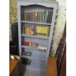 A blue painted five tier bookcase containing mixed books