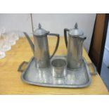 A four piece pewter coffee set with spot hammered decoration